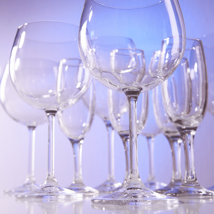 A Line of Glasses Placed on a Blue Color Background