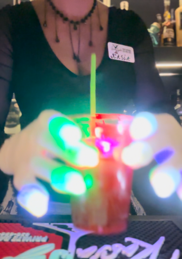 Close up image of drinks with lights in hand