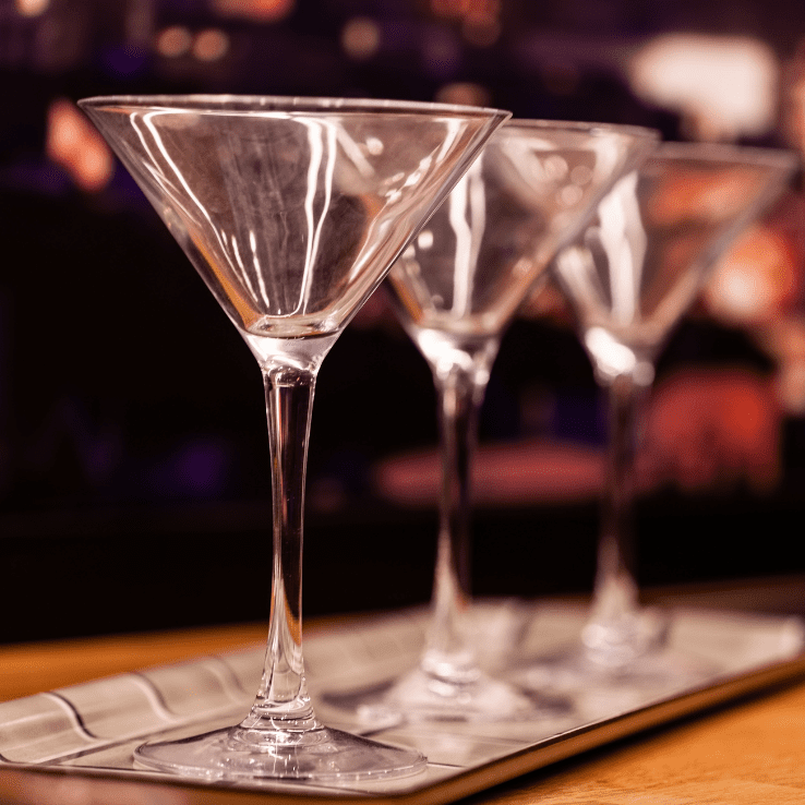 Three empty cocktail glasses kept on a table