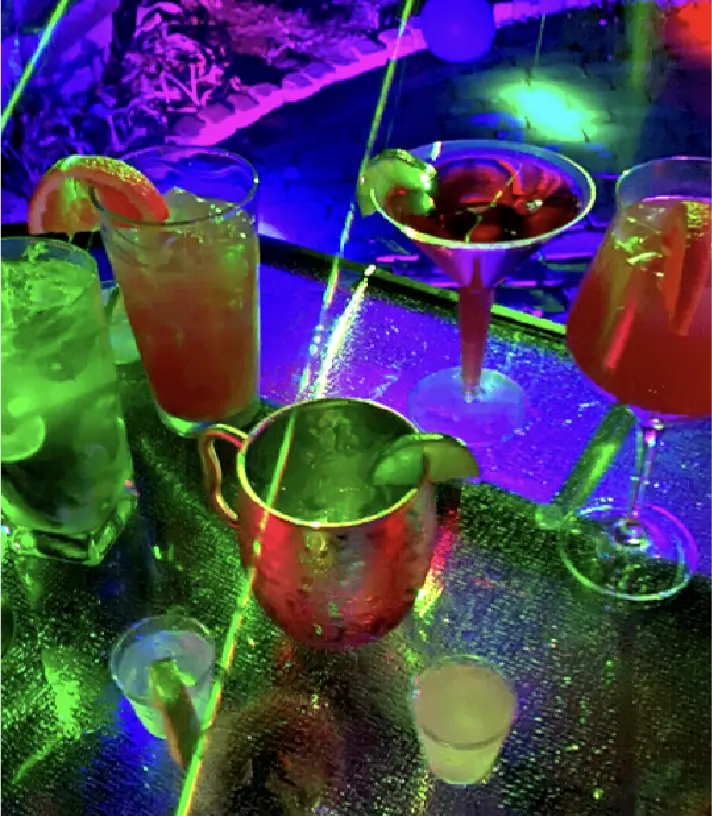 Some Juice And Cocktail Glasses Kept On A Table